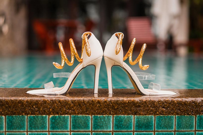 This photo shows bridal high heels at the hotel pool