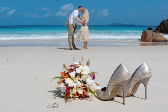 This photo shows the bides' shoes at the beach