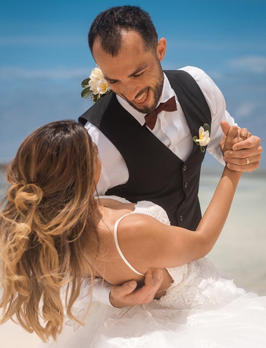 This photo shows a couple in happy mood dancing at the beach