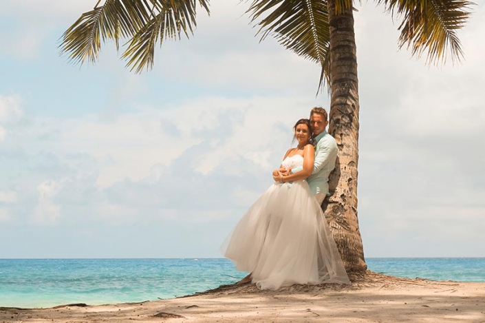 This photo shows couple portrait under a palmtree